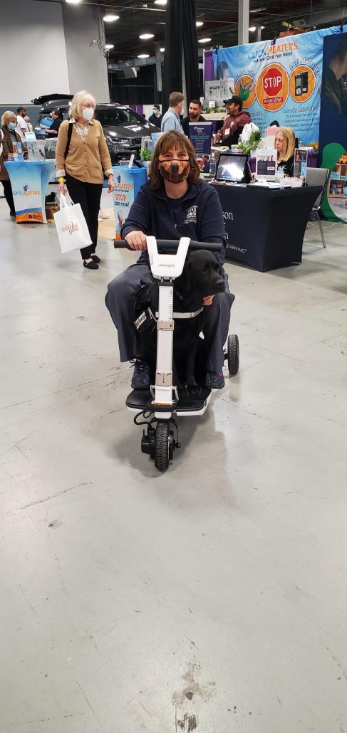 Help Hope Live client Amy Sherwood on a mobility scooter