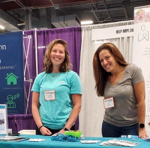 Kate Lacouture and Kelly L Green of Help Hope Live at the Help Hope Live booth of the 2022 Abilities Expo New York Metro